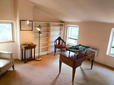 a living room with a foosball table and a lamp at Maison Robert in La Tour-dʼAigues