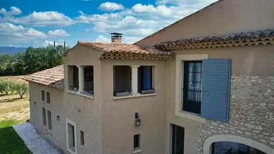 an external view of a house with a blue door at Bastide Saint Maurin in Ansouis