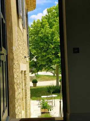 an open door to a patio with a tree at Bastide Saint Maurin in Ansouis