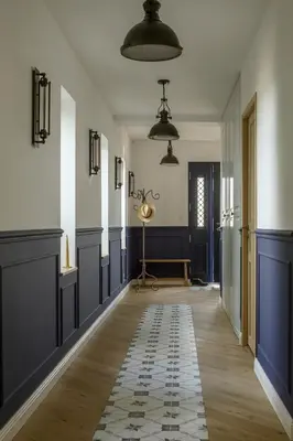 a hallway with blue and white walls and wooden floors at La Bastide Mas in Le Thor