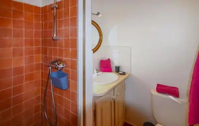 a bathroom with a sink and a toilet and a shower at Sarriette & Romarin in Apt