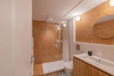 a bathroom with a sink and a toilet and a mirror at Appartement Belle Lettre 2 in Aix-en-Provence