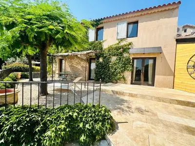 a house with a fence and a tree in front of it at La Réserve Provence in Vaugines
