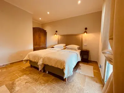 a bedroom with a large bed with two pillows at La Réserve Provence in Vaugines