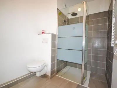 a bathroom with a toilet and a glass shower at Apartment Pigonnet by Interhome in Aix-en-Provence