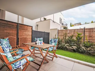 a patio with a wooden table and two chairs at Apartment Pigonnet by Interhome in Aix-en-Provence