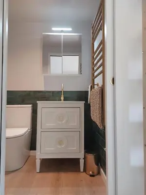 a bathroom with a white cabinet and a sink at villa spacieuse piscine jacuzzi 8 chambres 16 couchages in Saint-Chamas