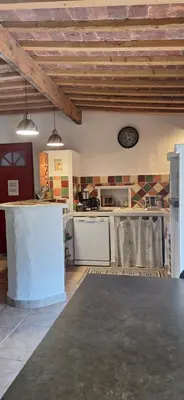 a kitchen with white appliances in a room at Complexe dans un grand Mas Provençal en campagne avec piscine privée in Monteux