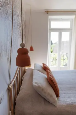 a bed with two pillows on it with a window at CHAMBRES D'HÔTES L'Oréliane en Provence Adults Only in Châteauneuf-de-Gadagne