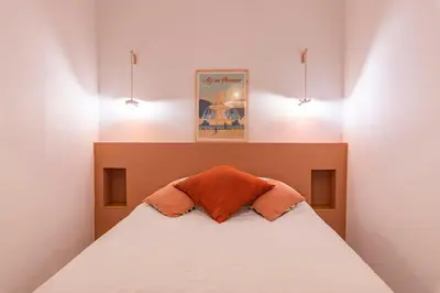 a bedroom with a bed with two pillows on it at Charme et Modernité au coeur d'Aix & Cours Mirabeau in Aix-en-Provence