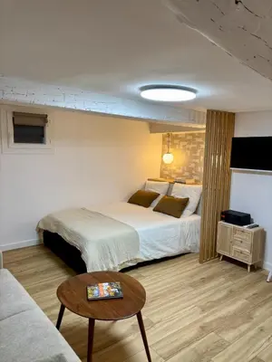 a hotel room with a bed and a table at Magnifique studio centre d'Aix & Cours Mirabeau in Aix-en-Provence