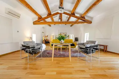 a living room with a table and chairs at Gite dans un Mas Provençal avec Jacuzzi in Oppède