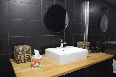 a bathroom with a white sink and a mirror at Cozy apartment in LʼIsle-sur-la-Sorgue