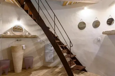 a staircase in a bathroom with a stair case at Gîte de charme face au Luberon, avec Jacuzzi in Oppède