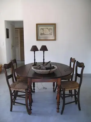 a wooden table with two lamps and two chairs at 