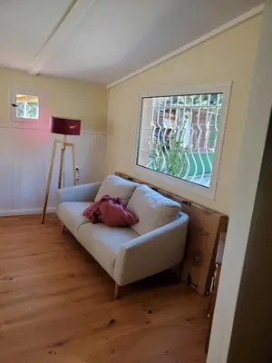 a living room with a white couch and a window at Charming house near village with 5-minutes pedestrian access to old town in Venelles