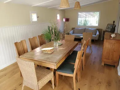 a dining room with a wooden table and chairs at Charming house near village with 5-minutes pedestrian access to old town in Venelles