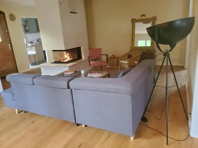 a living room with a gray couch and a camera at Charming house near village with 5-minutes pedestrian access to old town in Venelles