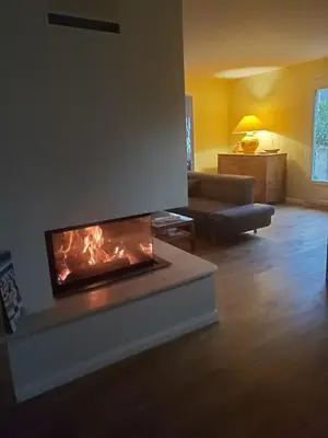 a living room with a fire place in the middle at Charming house near village with 5-minutes pedestrian access to old town in Venelles