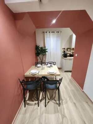 a dining room with a table and four chairs at Escapade sur la Sorgue in LʼIsle-sur-la-Sorgue