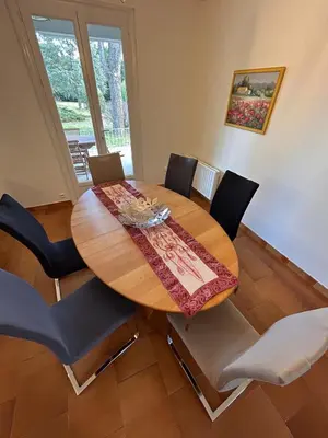 a dining room with a wooden table and chairs at Le Paradis au centre du Vaucluse in Saumane-de-Vaucluse