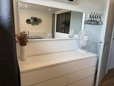a white dresser with a fan and a mirror at Chez Edouard - Superbe Triplex neuf - 6 chambres - Centre ville proche Rotonde allées provençales in Aix-en-Provence