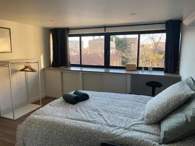 a bedroom with a large bed and a window at Chez Edouard - Superbe Triplex neuf - 6 chambres - Centre ville proche Rotonde allées provençales in Aix-en-Provence