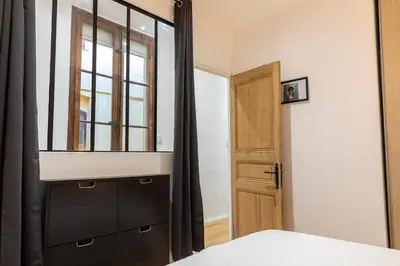 a bedroom with a black dresser and a mirror at Appartement centre Aix Terrace et ascenseur in Aix-en-Provence