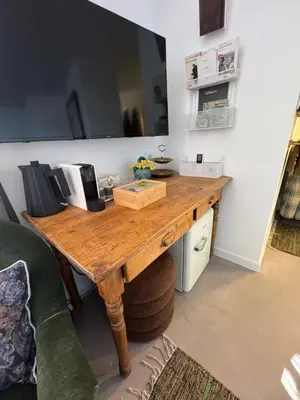 a wooden table in a room with a mirror at CaBaNa 52 La chambre Proche Lourmarin in Cadenet