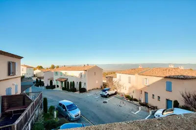 a street in a town with cars parked on the road at Les Coteaux de Pont Royal en Provence - maeva Home - Appartement climatisé 3 pièces 6 personnes - Prestige MAE-6331 in Mallemort