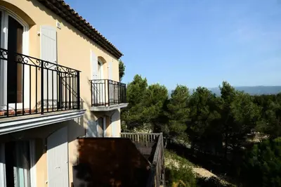 a building with balconies and a view of trees at Les Coteaux de Pont Royal en Provence - maeva Home - Appartement climatisé 3 pièces 6 personnes - Prestige MAE-6331 in Mallemort