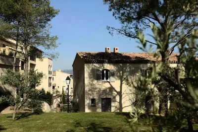 a large white building with trees in the foreground at Les Coteaux de Pont Royal en Provence - maeva Home - Appartement climatisé 3 pièces 6 personnes - Prestige MAE-6331 in Mallemort