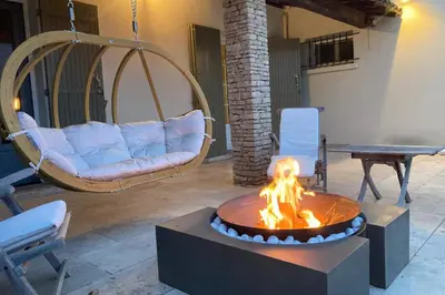 a fire pit in a living room with a couch at Beautiful Property Isle-sur-la-Sorgue in LʼIsle-sur-la-Sorgue
