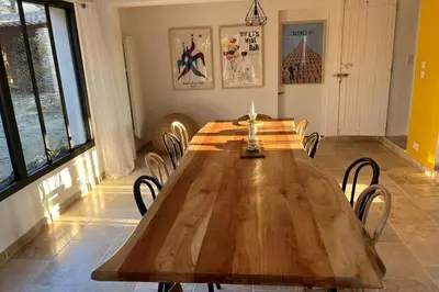 a large wooden table in a room with chairs at Beautiful Property Isle-sur-la-Sorgue in LʼIsle-sur-la-Sorgue