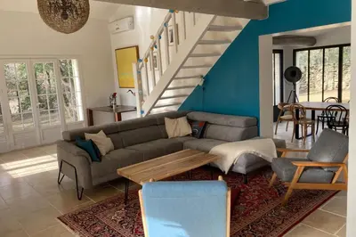 a living room with a couch and a table at Beautiful Property Isle-sur-la-Sorgue in LʼIsle-sur-la-Sorgue