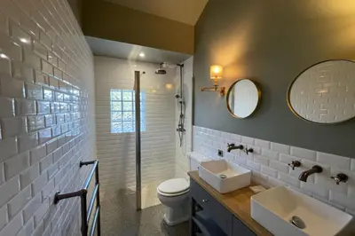 a bathroom with a sink and a toilet and a mirror at Magnificent Bourgeois House Renovated with Elegance and Art Deco Style in Le Thor