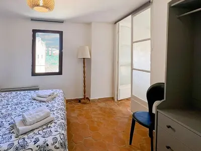 a room with a bed with two towels on it at Duplex centre de Roussillon avec Climatisation et vue in Roussillon