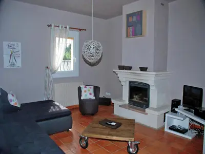 a living room with a couch and a fireplace at Holiday Home in L'Isle-sur-la-Sorgue with Pool in LʼIsle-sur-la-Sorgue