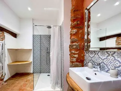 a bathroom with a sink and a glass shower at Apartment Roussillon village Ocre Air conditioning in Roussillon