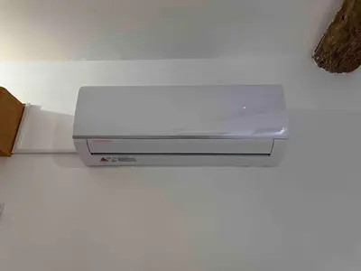 a white appliance sitting on top of a counter at Apartment Roussillon village Ocre Air conditioning in Roussillon