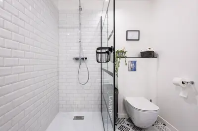 a white bathroom with a shower and a toilet at Basti Lou - Proche du village de Gordes in Gordes