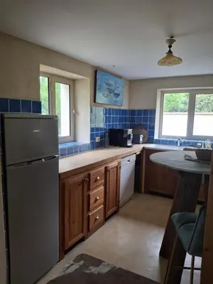 a kitchen with a refrigerator and a counter top at La Maison perchée - Mas de Rousseau in Eyragues