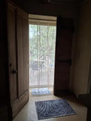 an open door leading to a patio with a table at La Maison perchée - Mas de Rousseau in Eyragues