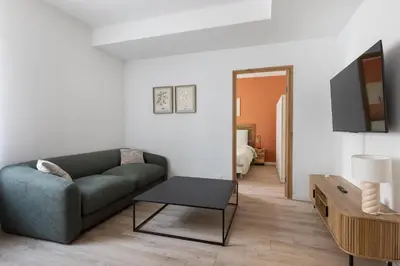 a living room with a couch and a table at Elégance en Luberon - 4 personnes - Central - Wifi in Apt