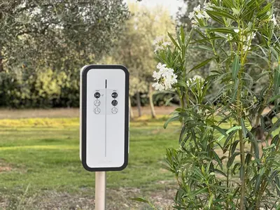 an iphone on a stick next to a bush at EcoLodge romantique proche Lourmarin Piscine Privée Borne recharge in Puyvert