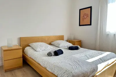 a bedroom with a bed with two pillows on it at L'Isle en coeur air-conditioned house with garden and swimming pool in LʼIsle-sur-la-Sorgue