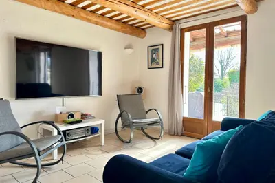 a living room with a blue couch and chairs at L'Isle en coeur air-conditioned house with garden and swimming pool in LʼIsle-sur-la-Sorgue
