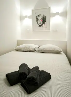 a bed with towels on it with two pillows at Le Solari - Studio lumineux au cœur du centre historique in Aix-en-Provence