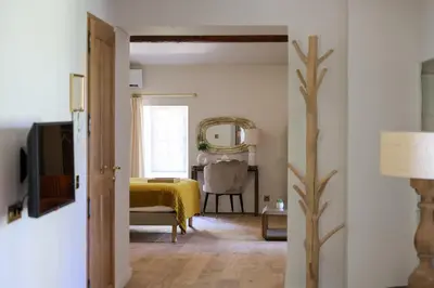 a bedroom with a yellow bed and a table at Domaine Robert in Rognes