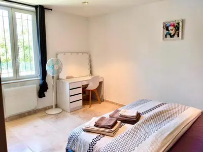 a bedroom with a bed and a desk and a window at Villa Provençale - Rognes campagne d'Aix en Provence in Rognes